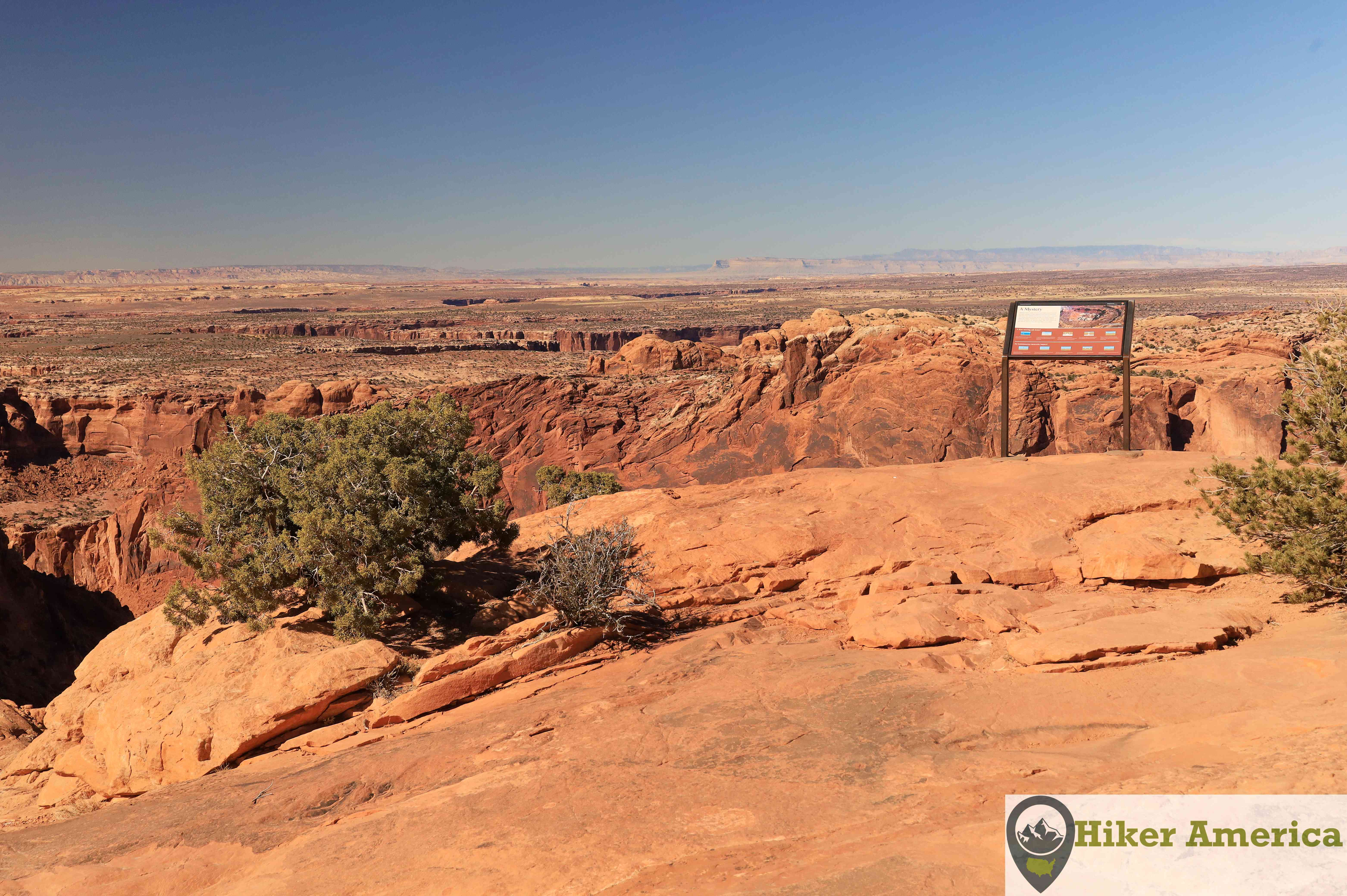 The Upheaval Dome Overlook with an interpretive sign.