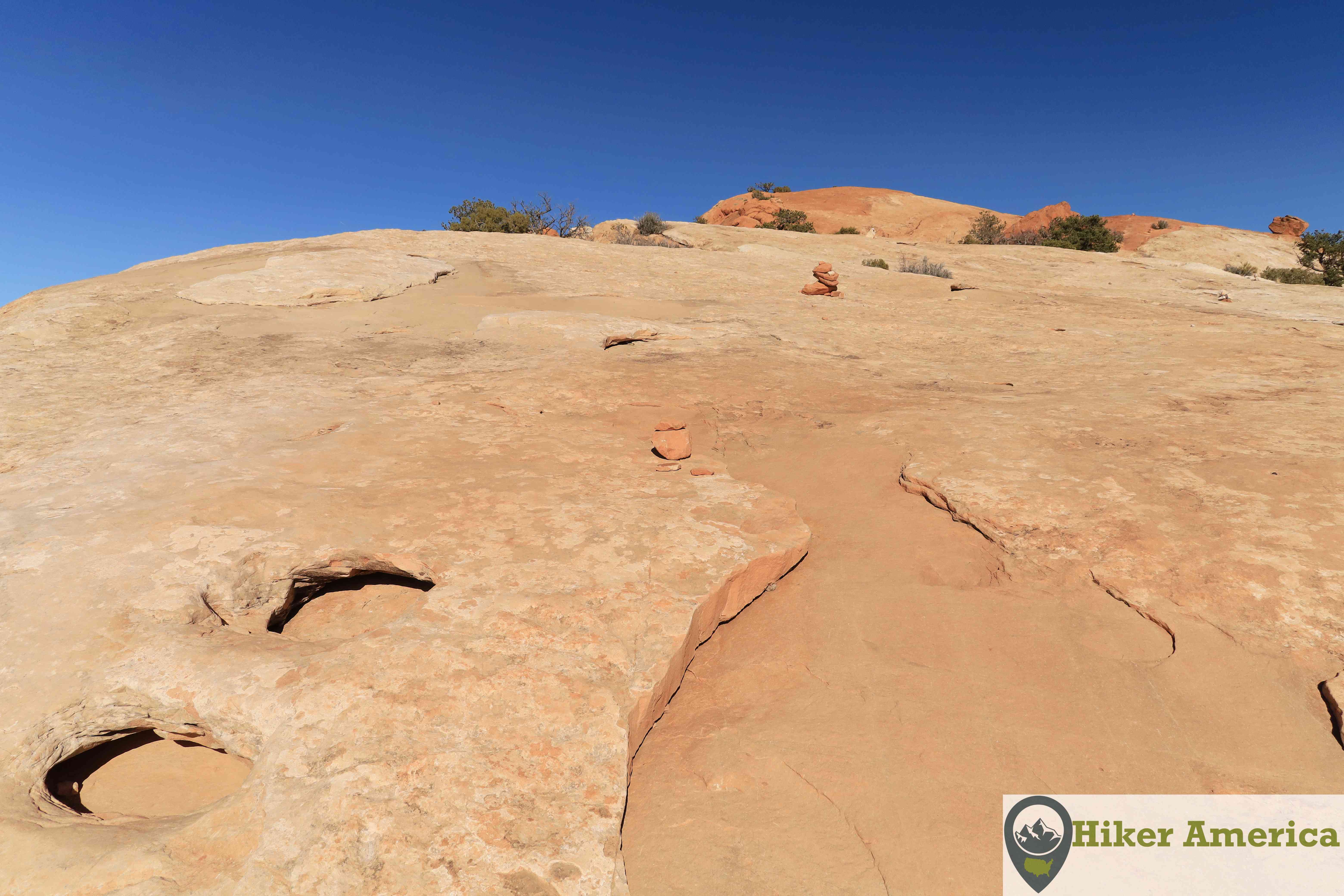 Rock cairns mark the way on the slickrock on the Upheaval Dome Trail.